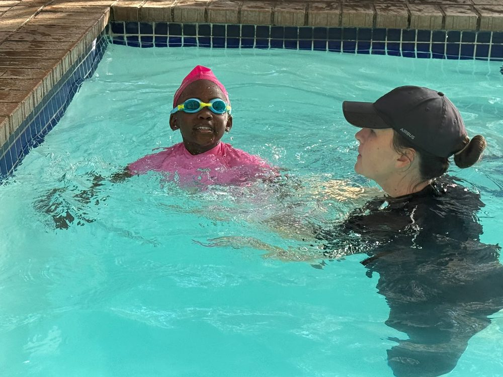 Instructor with a child wearing goggles during a lesson
