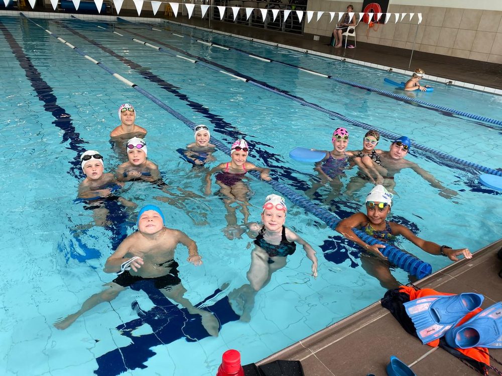 Squad swimmers training together in an indoor lap pool